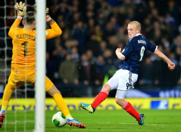 Stephen Naismith pounces on the rebound after Barry Bannan had seen his penalty saved. Picture: PA