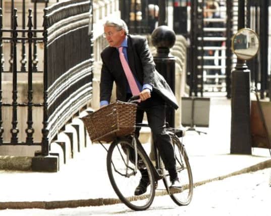 Andrew Mitchell cycles near Number 10. Picture: PA