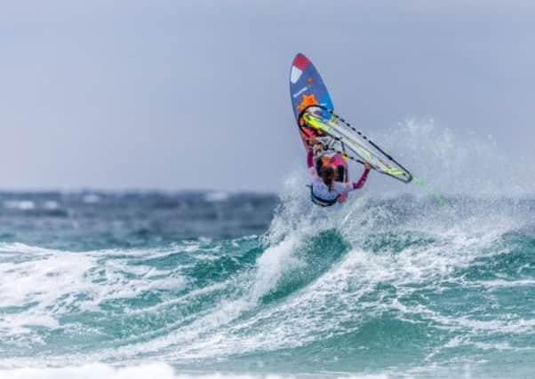 Poland's Justinya Sniady jumps a wave off Balephuil Beach. Picture: Dave White