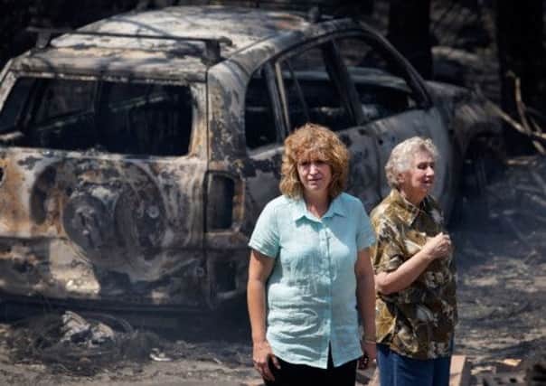 At Winmalee, New South Wales, Leanne Brown and her mother, Rosemary Booth, contemplate their ruined home. Picture: Getty