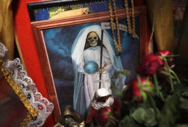 Santo Muerte  'Saint Death' plays a big part in the lives of many Mexican groups, including drug clans and prison gangs. Picture: Getty
