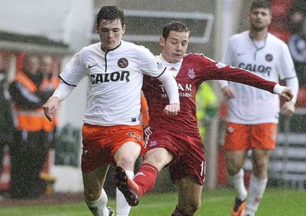 Dundee United's Andrew Robertson is closed down by Aberdeen's Peter Pawlett. Picture: SNS