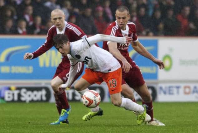 Dundee United's Ryan Gauld causes problems for Aberdeen duo Willo Flood, left, and Andrew Considine. Picture: SNS