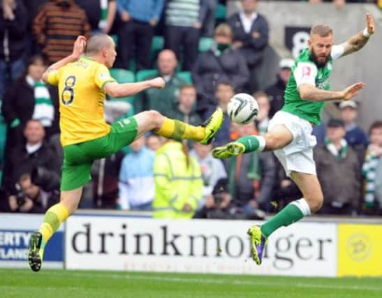 Celtic's Scott Brown and Hibs Rowan Vine challenge for the ball. Picture: Ian Rutherford