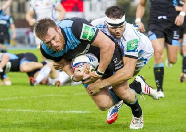 Tyrone Holmes (left) bundles the ball over the line to score the Glasgow Warriors' second try of the game. Picture: SNS