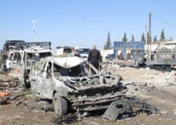 Security and emergency services at the site of the Hama City car bombing, in which at least 30 died. Picture: Reuters