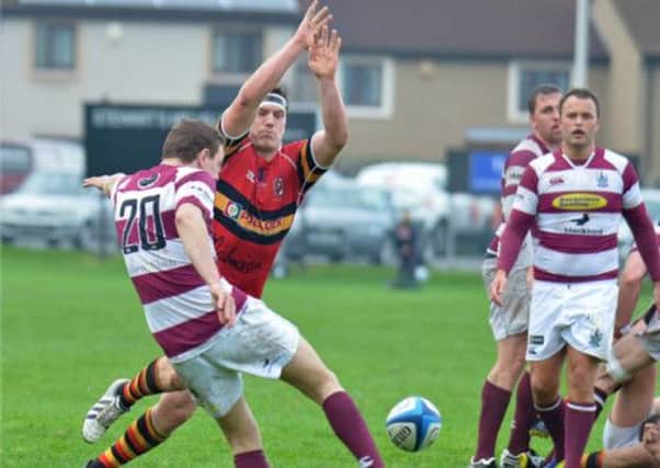 Ally Ledingham, of Watsonians, attempts to clear the ball past Fraser Morrison. Picture: Jon Savage