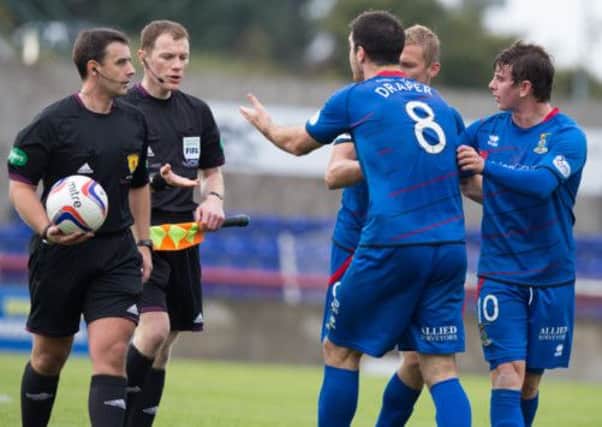 Inverness CT's Ross Draper is pulled away from referee Euan Norris after their goal was disallowed. Picture: PA
