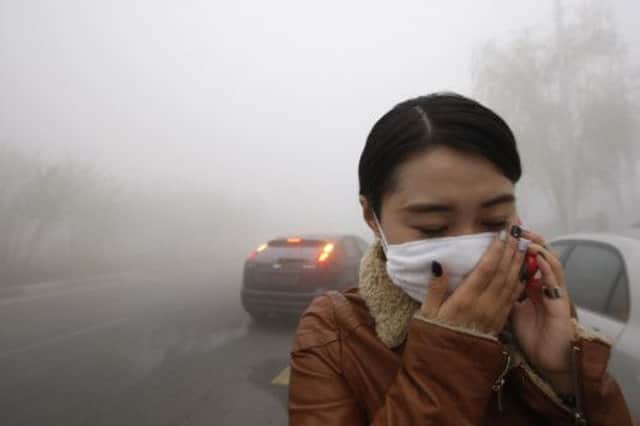 A woman in Harbin wears a mask to cut out the pollution. Picture: Getty