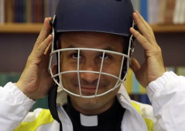 Monsignor Sanchez de Toca y Alameda wears a cricket helmet during the presentation of the Vatican cricket club. Picture: AP