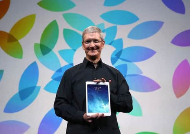 Apple CEO Tim Cook holds the new iPad Air. Picture: Getty
