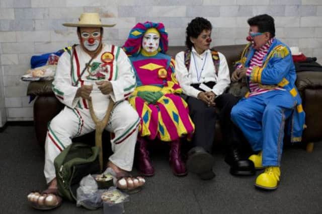 Clowns of all ages gathered to condemn violence and say real clowns are easily identified by costume. Picture: AP
