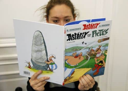 A girl reads Asterix and the Picts in French. Picture: Getty