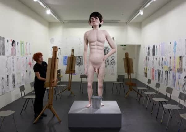 A woman sketches the work by artist David Shrigley entitled 'Life Model', which is part of the Turner Prize exhibition. Picture: Reuters