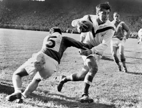 David Valentine, who captained Great Britain to World Cup glory, breaks a French tackle in the 1954 final.  Picture: Empics