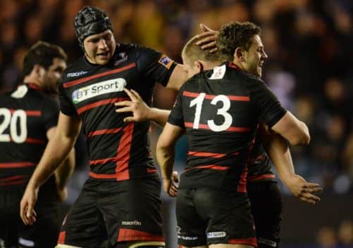 Edinburgh's WP Nel is congratulated by his team-mates after he bagged himself a try. Picture: SNS