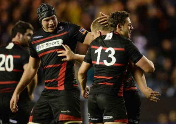 Edinburgh's WP Nel  is congratulated by his team-mates after he bagged himself a try. Picture: SNS