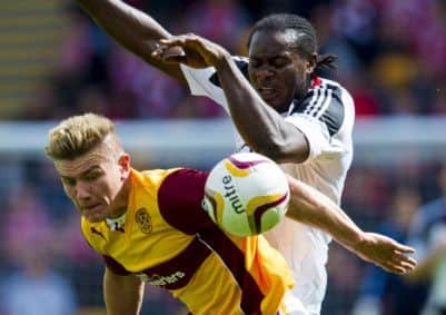 Motherwell's Shaun Hutchinson is challenged by Calvin Zola in Aberdeen's 3-1 win in the league. The pair meet in the League Cup on Wednesday. Picture: SNS