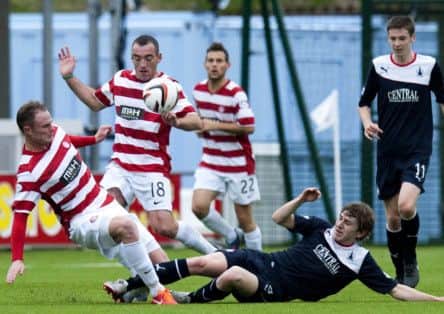 Falkirk's Blair Alston, right, slides in on Hamilton's Jon McShane in a feisty encounter. Picture: SNS