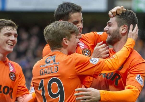 Nadir Ciftci is hailed by Andrew Robertson (left) Ryan Gauld and Brian Graham after opening the scoring. Picture: SNS
