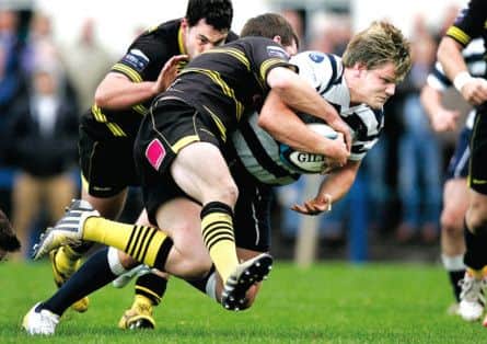 George Turner of Heriot's runs into trouble at Goldenacre as Melrose close ranks. Picture: Toby Williams