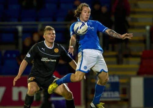 St Johnstone's on-song striker Stevie May takes possession as Shaun Hutchinson of Motherwell looks on. Picture: SNS