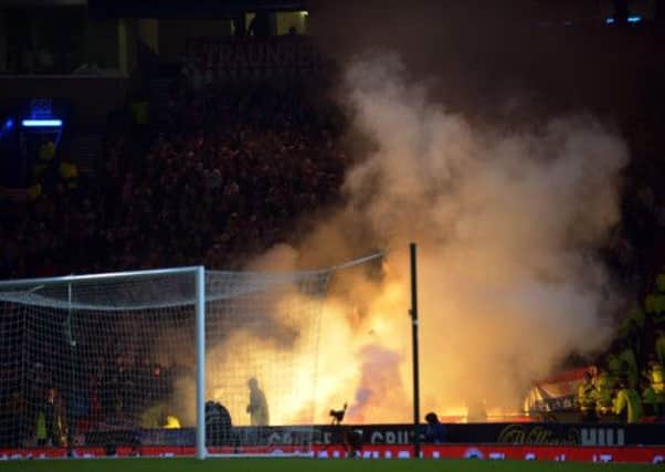Croatian fans let off flares in the stadium during the clash at Hampden. Picture: Phil Wilkinson