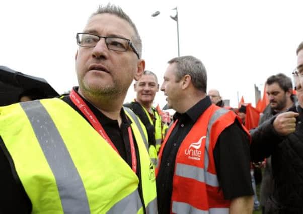Stephen Deans, left, speaks to a colleague during a union rally at Grangemouth. Picture: Michael Gillen