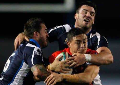 Tongan Daniel Foster is halted by Mitchell Stringer and Luke Douglas. Picture: Getty