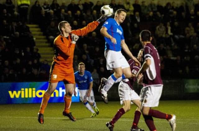 Jon Daly rises above Chris Smith to head in the winner. Picture: SNS