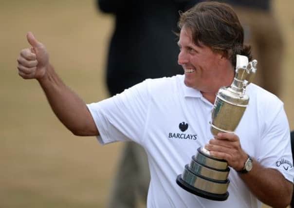 Phil Mickelson celebrates winning last year's Open - but 18,000 fewer watched him than saw Ernie Els win in 2002. Picture: Jane Barlow