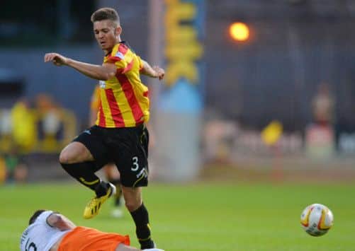 Aaron Taylor-Sinclair hurdles a challenge from Dundee United's Paul Paton. Picture: Getty