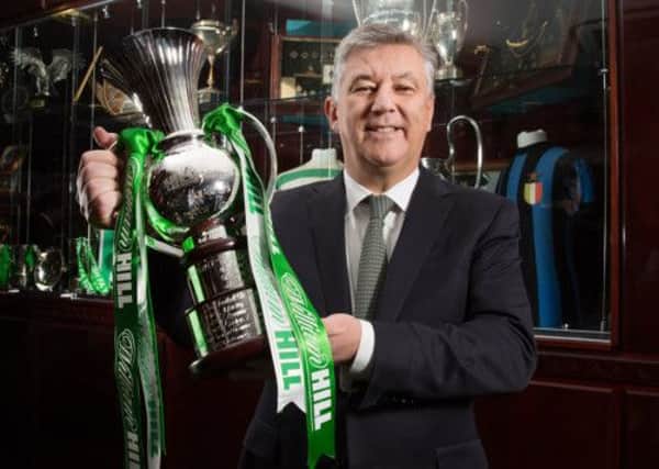 Celtic chief executive Peter Lawwell shows off a specially commissioned trophy which was presented to the club yesterday. Picture: Steve Welsh