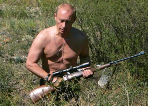 Vladimir Putin carrying a hunting rifle in the Republic of Tuva. Picture: Getty