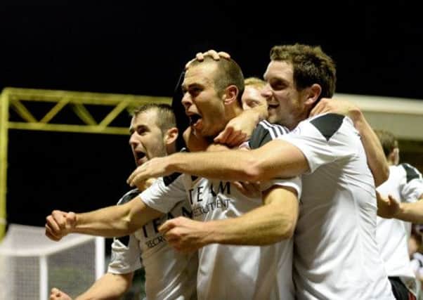 Andrew Considine (centre) is mobbed by his team mates after scoring late in the match. Picture: SNS