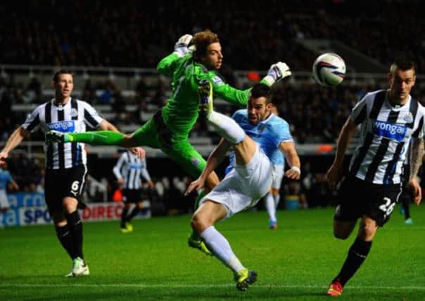 Newcastle keeper Tim Krul clears the ball as Alvaro Negredo tries to get a shot away. Picture: Getty Images