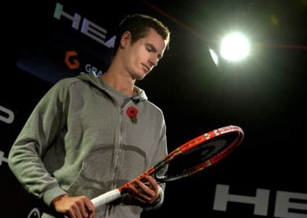 Andy Murray poses with his new Head tennis racket. Picture: PA