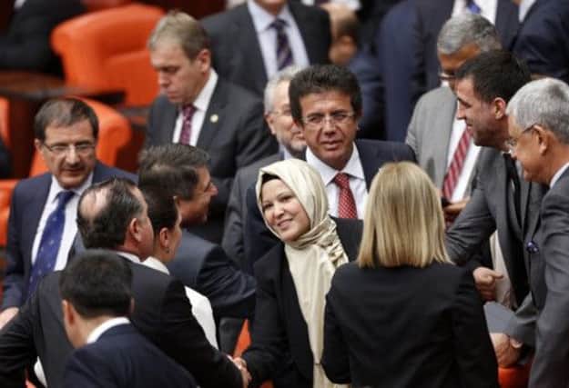 MP Nurcan Dalbudak is congratulated by colleagues from the ruling AKP in the Ankara parliament yesterday. Picture: Reuters