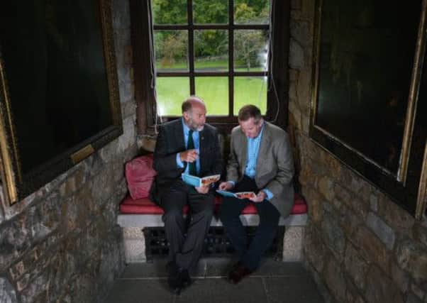 Alistair Moffat, Festival Director and Author Neil Francis look through this years programme. Picture: Neil Hanna