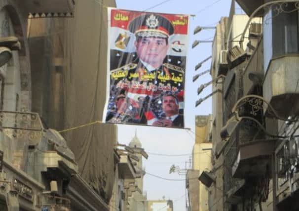 A poster of General Abdel Fattah alSisi hangs near souvenir shops in a tourist area in Cairo. Picture: Reuters