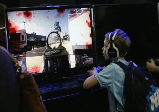 Members of the public play the video game 'Battlefield 4' at 'Gadget Show Live @ Christmas'. Picture: Getty