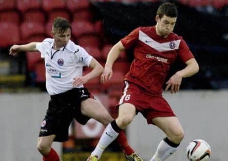 Scott Ferguson, left, and Brora's Gavin Morrison cant keep their feet on the ground as they battle for the ball. Picture: SNS Group
