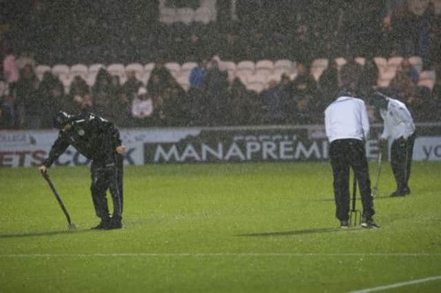 St Mirren youth players try to help clear the pitch. Picture: SNS
