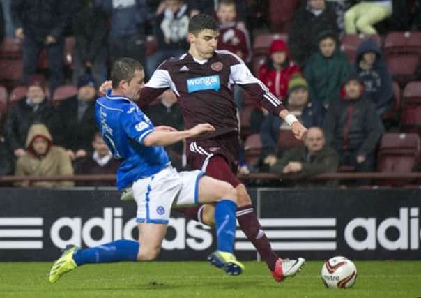 Hearts' Calum Patterson attempts to cross under pressure from Tam Scobbie. Picture: SNS