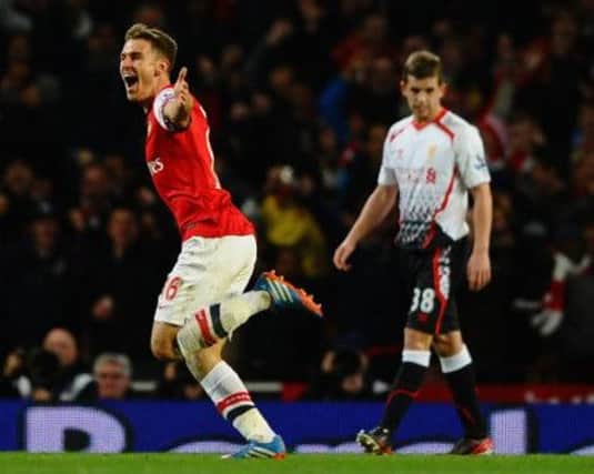 Aaron Ramsey celebrates his brilliant volleyed goal against Liverpool yesterday. Picture: Getty