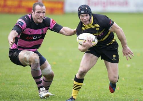 Ayrs James Eddie, left, closes down Richard Mill. Picture: SNS