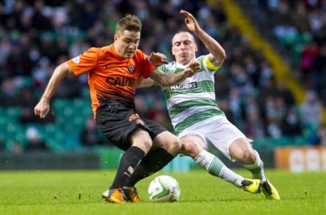 Scott Brown challenges Dundee United's Paul Paton in the 1-1 draw. Picture: SNS