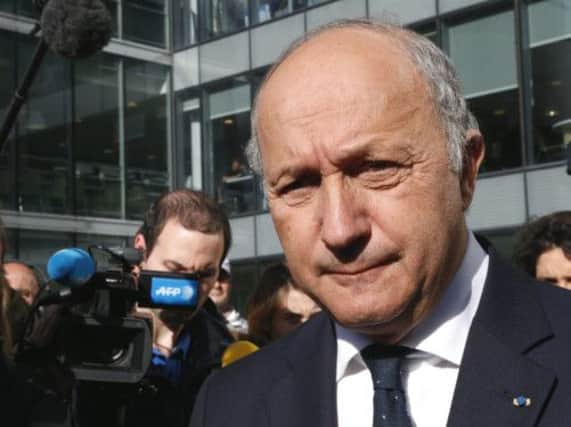 French Foreign Minister Laurent Fabius leaves  after visiting French radio station RFI headquarters. Picture: AP