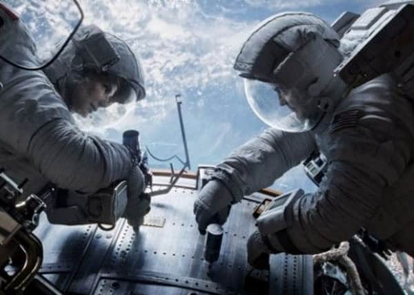 Sandra Bullock, left, as Dr. Ryan Stone and George Clooney as Matt Kowalsky in Gravity." Picture: AP