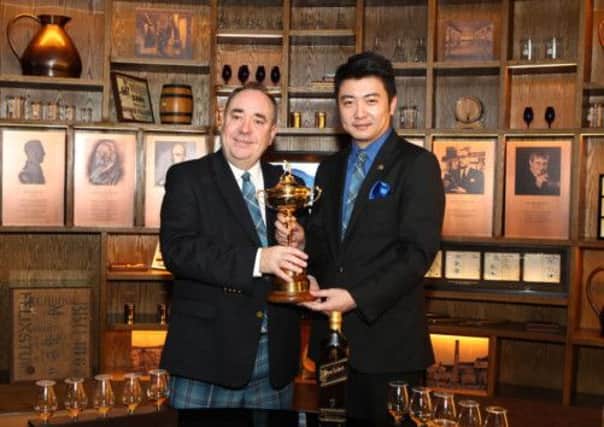 First Minster Alex Salmond is on a trade visit to China. Salmond is pictured with Liu Wei, Johnnie Walker Brand Ambassador for China, and the Ryder Cup trophy. Picture: PA